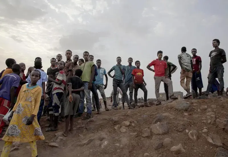 Ethiopian migrants stand on a hill at a slum in Dikhil, Djibouti, where they took shelter after entering the country, July 12, 2019, on their journey to Yemen. Most hope to eventually reach Saudi Arabia. Image by AP Photo / Nariman El-Mofty. Djibouti, 2019.