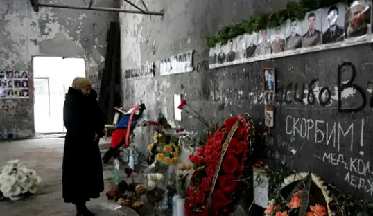 Svetlana Tsgoyeva, 69, visits the hall where her granddaughter, Zalina Albegova, 9, died in 2004. Image by Tom Parfitt. North Ossetia, Russia, 2011. image