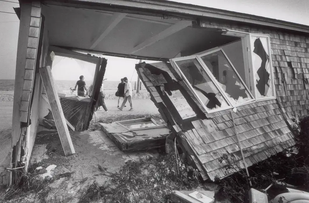 1991: A cottage sat in a new location after Hurricane Bob lifted it and moved it across the street on Surf Drive in Falmouth. Image by Mark Wilson. United States, 1991.