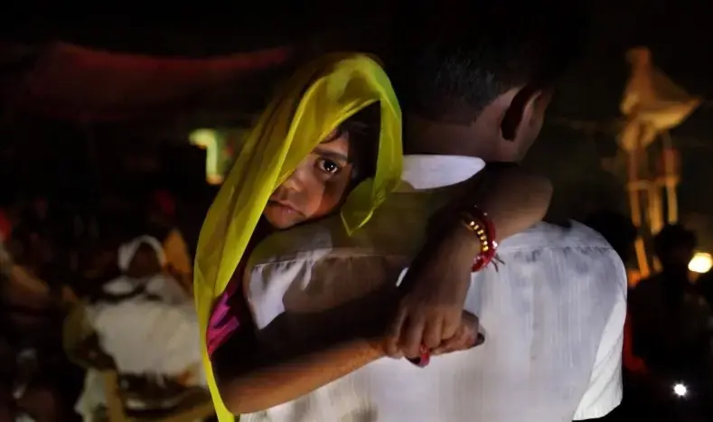 Rajni, 5, was woken up at 4 am and carried by her uncle to be married in a secret wedding ceremony on the Hindu holy day of Akshaya Tritiya in North India. Image by Stephanie Sinclair/VII for National Geographic. India, 2010. Media file: child-bride-india-stephanie.sinclair.jpg