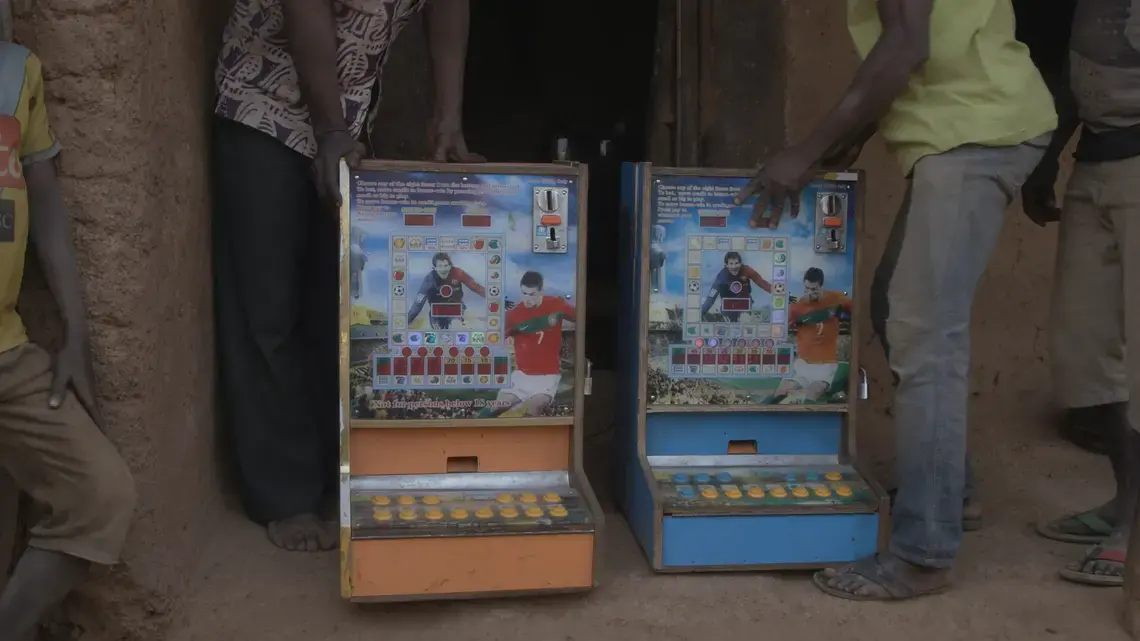A pair of gambling machines in Zamashegu. Minimum bets on machines like these are 20 to 50 Ghanaian pesawas—about 5 to 10 cents. Image by Noah Fowler. Ghana, 2017.