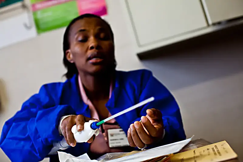 Midwife Sharon Hobo explains the manual vacuum aspirator, a tool for abortions in the first trimester. Photo by Jake Naughton. South Africa, 2012. Media file: dora-nginza.jpg