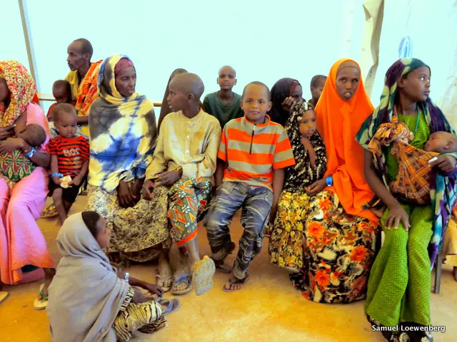 New arrivals at a Kenyan refugee camp received a medical examination and a food voucher. Image by Sam Loewenberg. Kenya, 2011. image