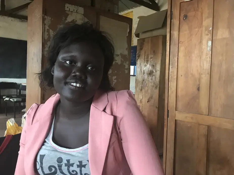 Jessica Deng, 21, was born and raised in Kakuma. Now she teaches math at Bhar-El-Naam. Image by Jaime Joyce. Kenya, 2018. Jessica Deng, 21, was born and raised in Kakuma. Now she teaches math at Bhar-El-Naam. Image by Jaime Joyce. Kenya, 2018.
