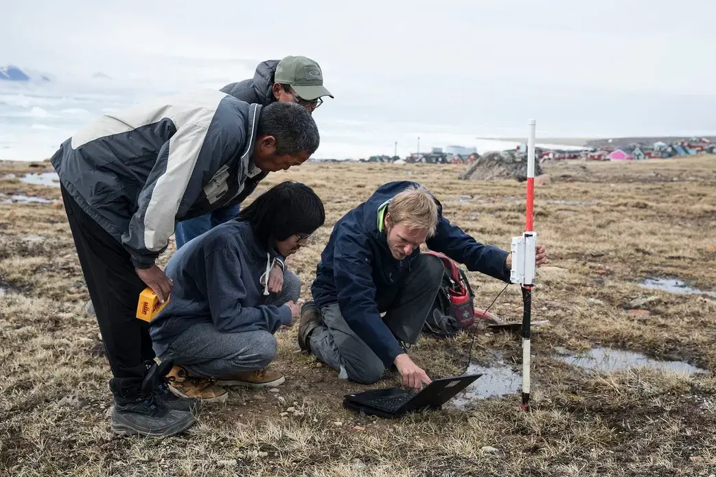 Sebastian Zastruzny, a researcher at the Center for Permafrost (CENPERM) who has been studying permafrost in the region for several years, takes measurements with the help of Qaanaaq residents. There is no word for permafrost in the Greenlandic language. Greenland, 2019. Image by Anna Filipova. 