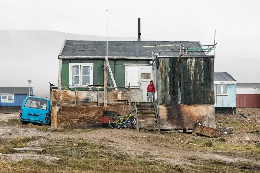 A family lives in this sinking, rotting home. The worst damage is done in autumn and spring, when the ground freezes and thaws. Increased rainfall in the autumn can also wreak havoc. Greenland, 2019. Image by Anna Filipova.