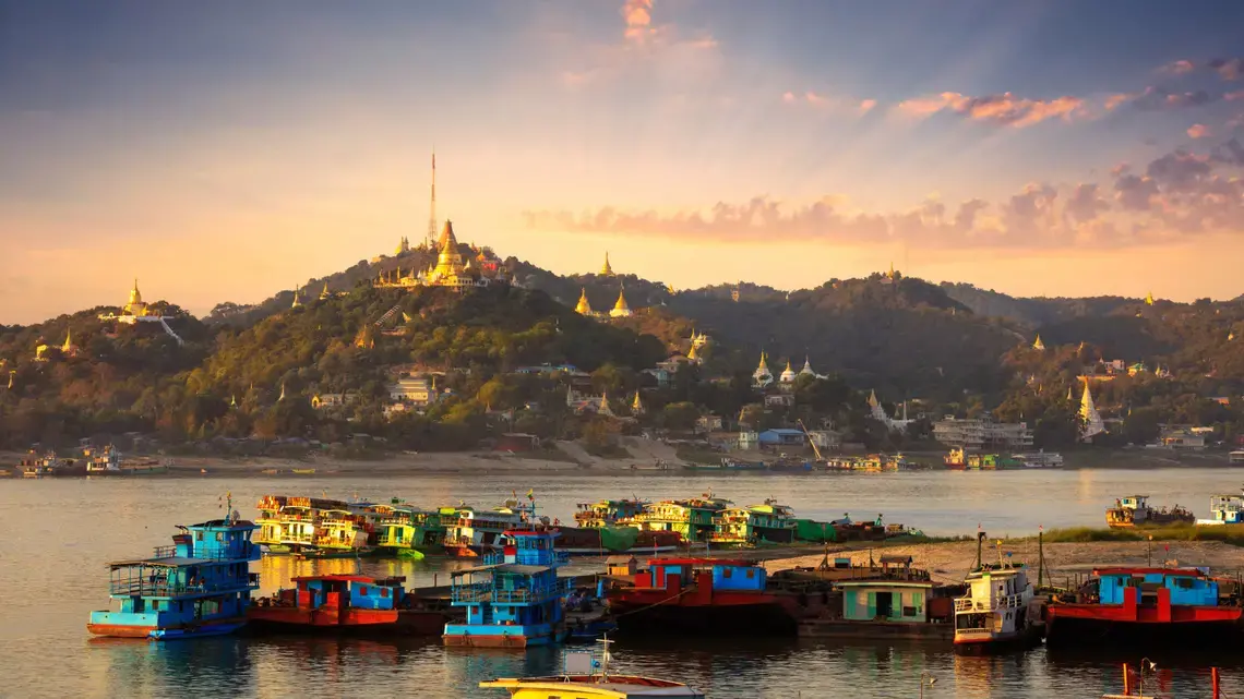 Cargo boats on the Irrawaddy River in Mandalay, Myanmar. Image by Doug Bock Clark. Myanmar, 2018.
