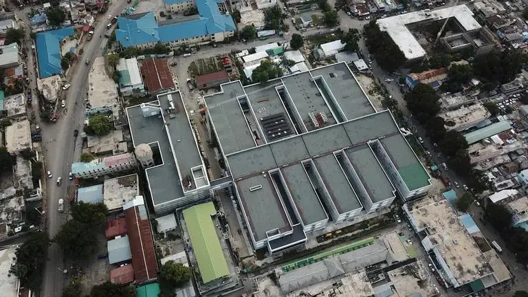 Aerial view of the new State University of Haiti Hospital in Port-au-Prince. The sprawling new hospital campus was one of the first projects approved for Haiti’s reconstruction after the Jan., 12, 2010 earthquake. A decade later, the 534-bed teaching hospital has yet to open its doors to a single patient. Image by Jean Marc Hervé Abélard / The Miami Herald. Haiti, 2019. Aerial view of the new State University of Haiti Hospital in Port-au-Prince. The sprawling new hospital campus was one of the first projects approved for Haiti’s reconstruction after the Jan., 12, 2010 earthquake. A decade later, the 534-bed teaching hospital has yet to open its doors to a single patient. Image by Jean Marc Hervé Abélard / The Miami Herald. Haiti, 2019.