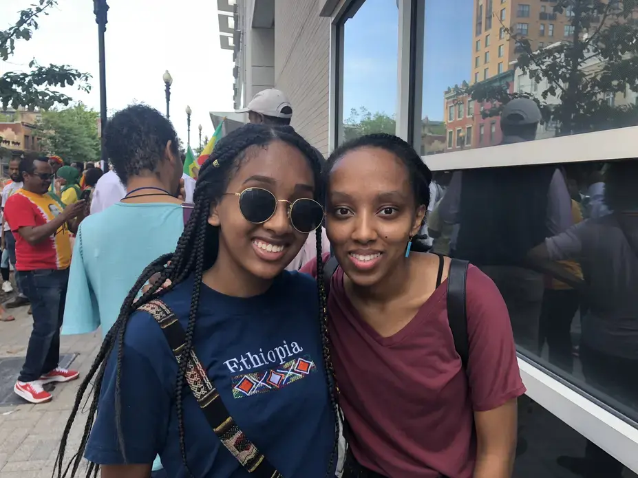 Naomi Bergena (left) and her friend are both first generation Ethiopian-Americans who came to support Abiy on July 28. The recent changes in Ethiopia have inspired her to become more engaged with her Ethiopian identity. Image by Claire Potter. United States, 2018.