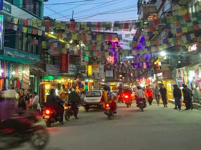 Thamel, the tourist hub of Kathmandu, overflows with gift shops, trekking agencies, and Western restaurants. When tourists and locals support Thamel's entertainment sector by frequenting dance bars, massage parlors, and cabin restaurants, they maintain the demand for the sexual exploitation of the girls and women working there. Image by Nicole Brigstock. Nepal, 2018.