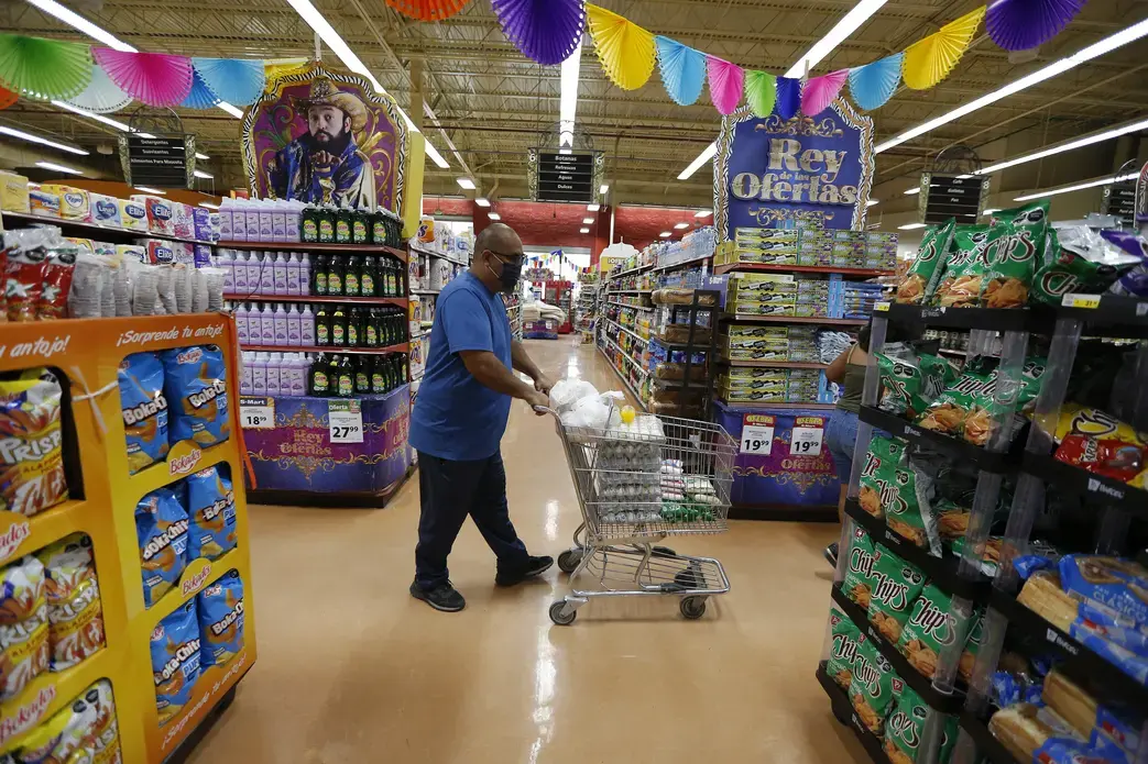 CHEVRESTT_11A.jpg Juan Ortiz in supermarket with cart