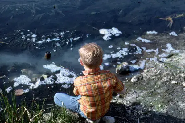 In 1969, a boy fishes in polluted Florida waters. Image from the State Archives of Florida. United States, 1969.