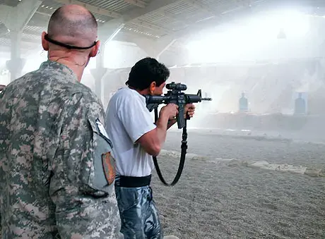 Major Dillon Haynes showing an Iraqi trainee how to shoot an M4. Minutes later the range was mobbed by administrative staff; photo by Dimiter Kenarov. 1