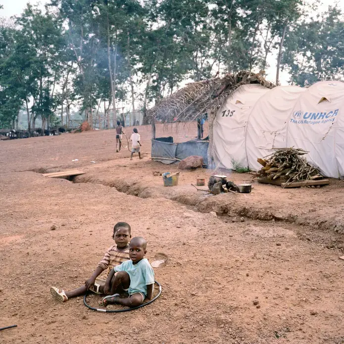 Young children play with tent poles at the Nahibly refugee camp outside of Duekoue, Ivory Coast, on March 7, 2012. Duekoue was the site of heavy fighting and a large massacre that saw hundreds dead during last year's post-election violence, and many people still refuse to leave the relative comfort and security of the refugee camp to return home. Image by Peter DiCampo. Ivory Coast, 2012. Media file: ivory_coast_017.jpg