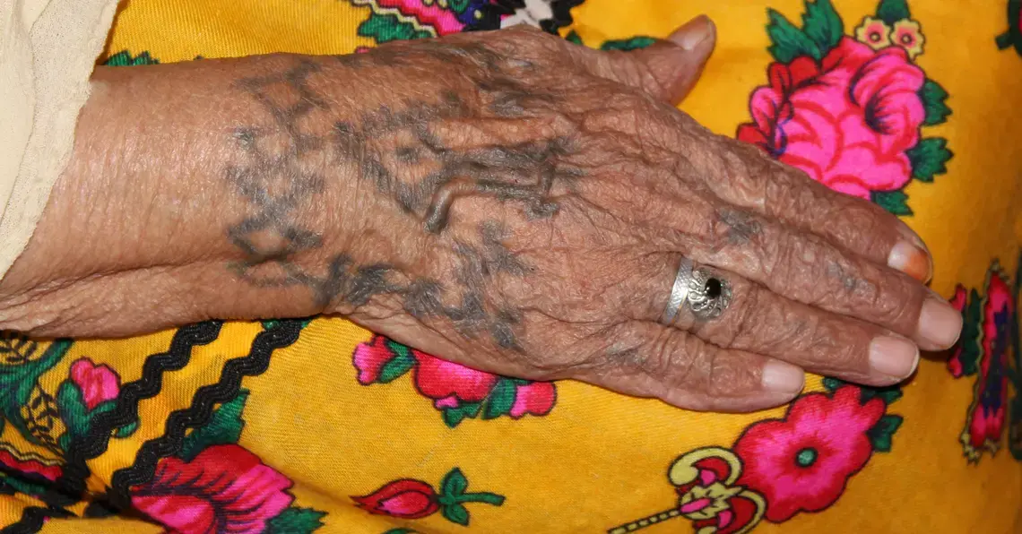 The tattoos on Janat's right hand remain clear though she received them over 60 years ago. Tattoos such as these were often made to improve health and healing. Janat's hand tattoo was supposed to promote fertility. Image by Yasmin Bendaas. Algeria, 2012. Media file: janatshand.jpg