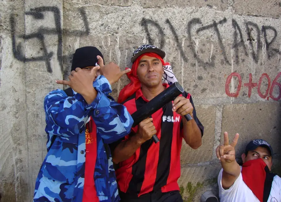 Members of the Sandinista Youth pose with homemade mortars. The ruling party's official youth group, which has been called on repeatedly in recent years as security thugs to put down opposition protests, has helped Daniel Ortega establish a one-party system in Nicaragua. Image by Tim Rogers. Nicaragua, 2012. Media file: js19.JPG