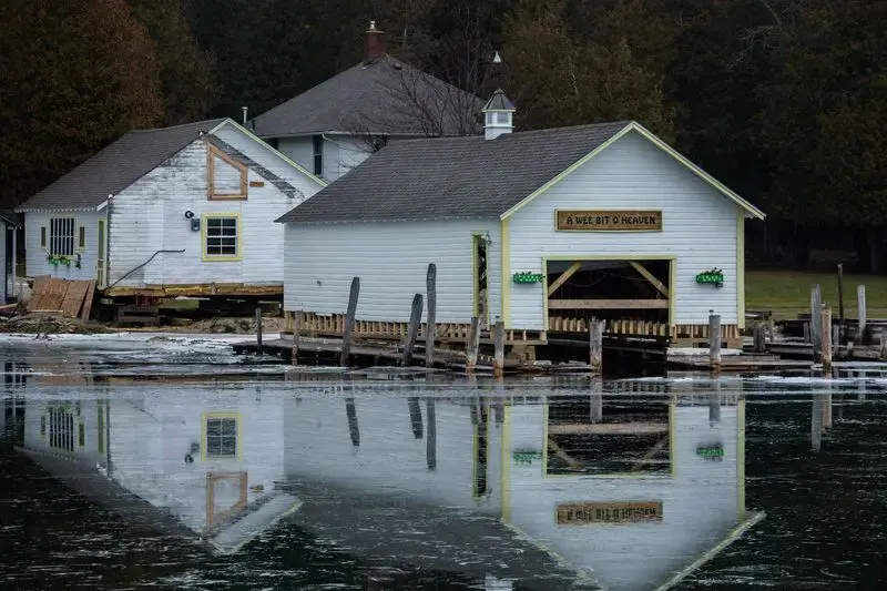 Boathouses are being removed from flooded docks in Snows Channel at Les Cheneaux Islands in the Upper Peninsula of Michigan on Nov. 20, 2019. Image by Zbigniew Bzdak / Chicago Tribune. United States, 2020.