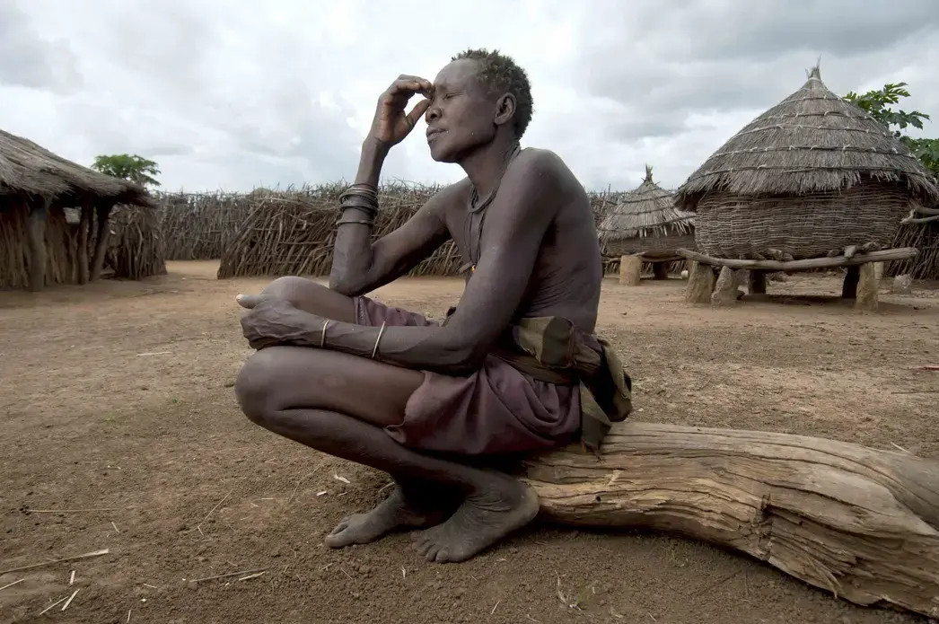 Lokwii Nakuro lost her husband during an attempted cattle raid when he was shot in front of their hut. Now she and the rest of her family struggle to eke out a living by farming. Image by Marc Hofer. Uganda, 2011. image