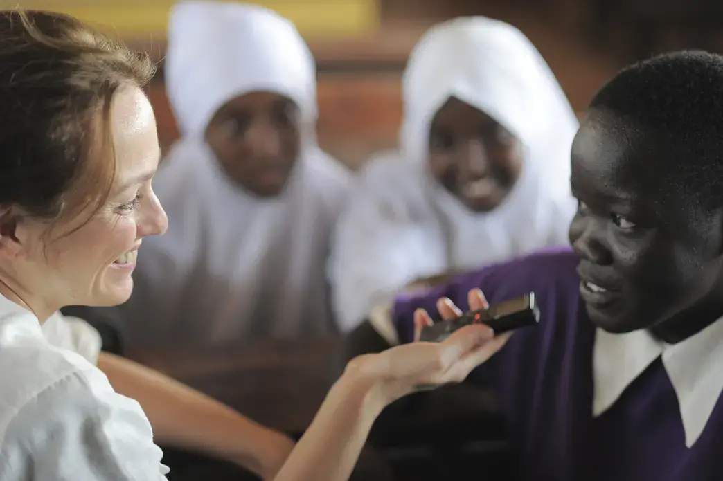 TFK’s Jaime Joyce talks with Rachel Akol Dau, 17, a refugee from South Sudan. “I want to be a journalist,” Rachel says. Image by Rodger Bosch for UNICEF USA. Kenya, 2018.