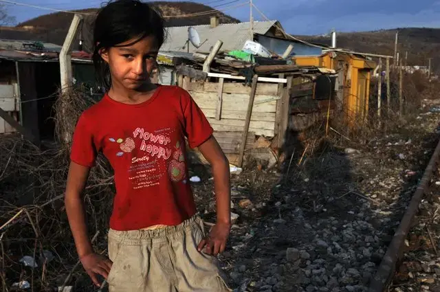 A Roma girl stands near her home in the Chesmin Lug camp. Between 2005 and 2008, Zoran Savich, a pediatrician with the Health Center of Kosovo Mitrovica, saw more than 300 patients in Osterrode and Chesmin Lug. In that time, 77 people died of lead poisoning, many of them children. "I treated as many as I could but they were living in the same conditions and absorbing lead," Dr. Savich said. "When the treatments stopped, their levels went back up. It was useless." 1
