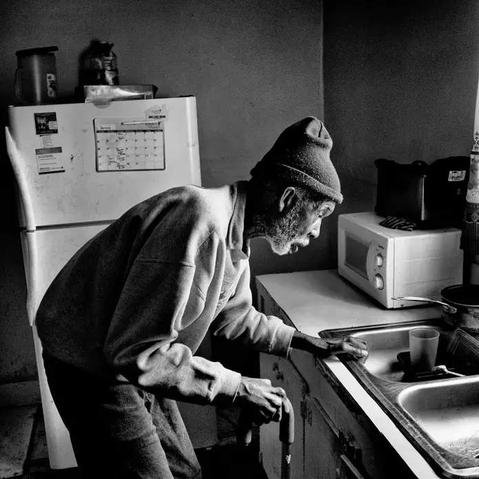 Denmark, S.C. | Saint Joseph Johnson, who died in January, in his kitchen last year; many in the town don’t use tap water, saying the chemical HaloSan, which was added to protect pipes, has led to health issues. Image by Matt Black—Magnum Photos for TIME. United States, 2019.
