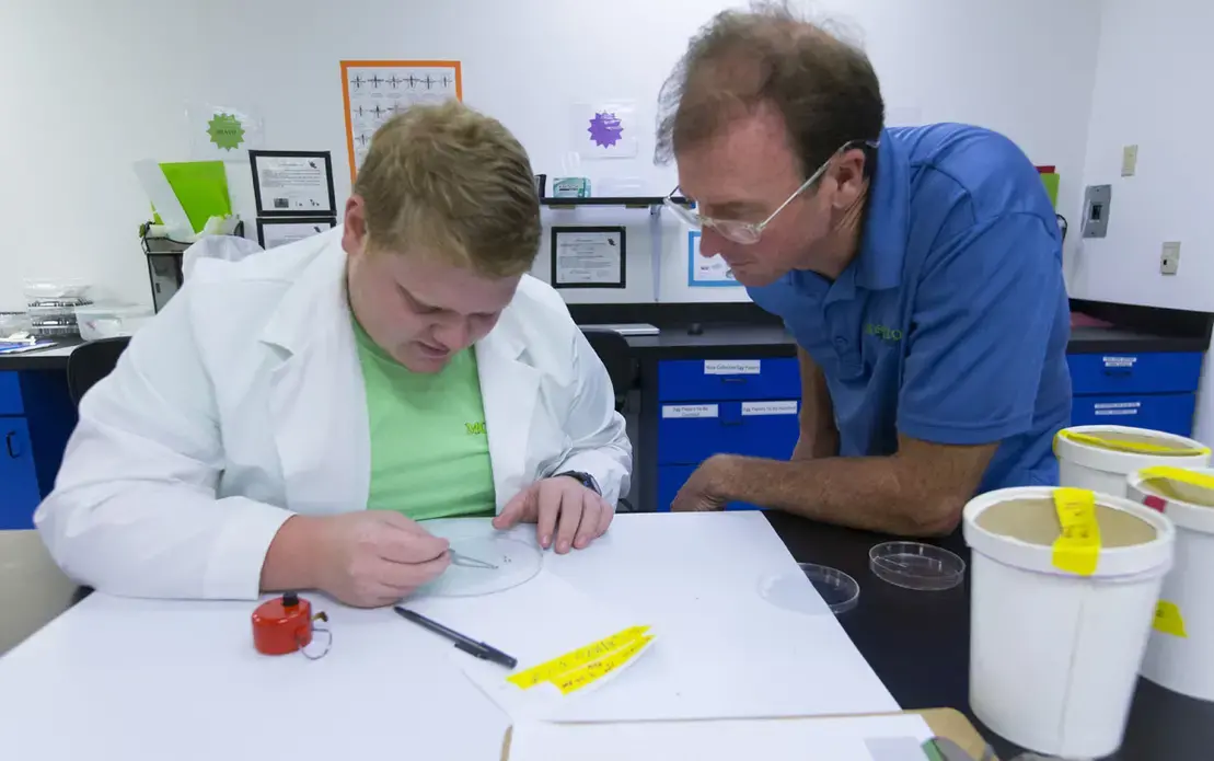 Student intern Matthew Moore and operations manager William Bacon inventory dead mosquitoes at MosquitoMate in Lexington, Ky. MosquitoMate breeds mosquitoes carrying a bacterium called Wolbachia within their cells. The eggs they fertilize never fully develop. Image by Mark Hoffman. United States, 2017. 