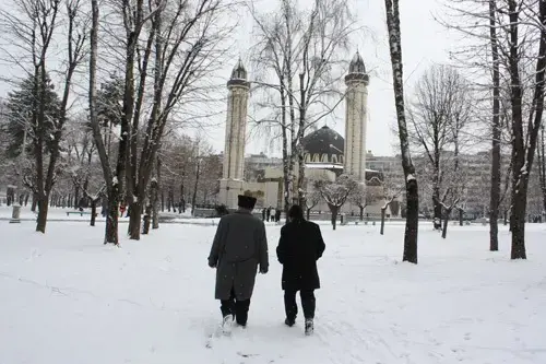 Men hurry to Friday prayers at the central mosque in Nalchik, the capital of the Russian republic of Kabardino-Balkaria. Image by Tom Parfitt. Russia, February 2011.