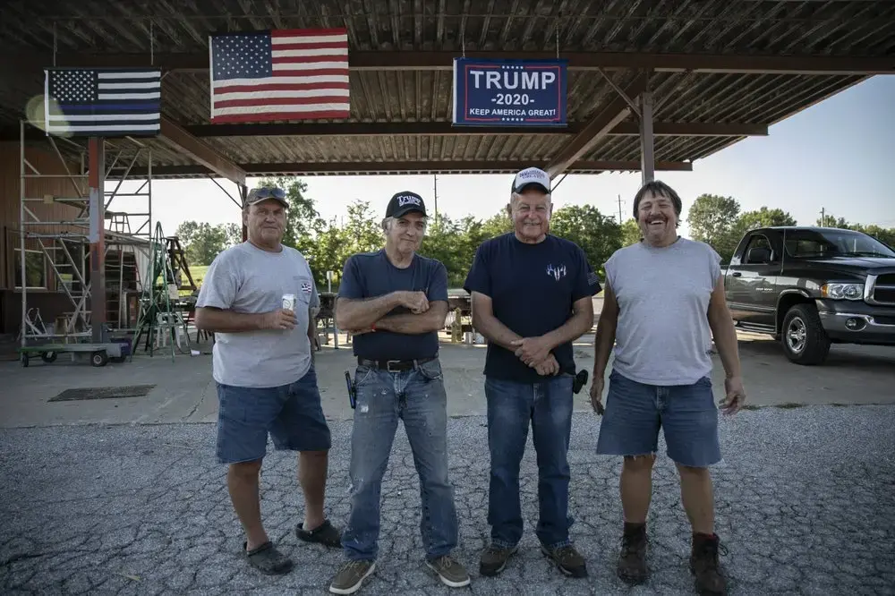 Trump supporters Jim Rainbolt, 57, left, Rick Warren, 65, Bill Stevens, 76, and Roger Plott, 65, stand outside their clubhouse in West Vienna, Ill. Image by Wong Maye-E/AP Photo. United States, 2020.