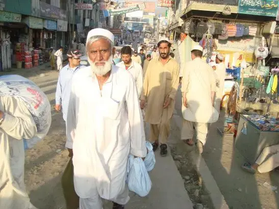 People walking along the main bazaar in Mingora, Swat Valley. Image by Shaheen Buneri. Pakistan, 2011. Media file: pakistan-mingora-swat.jpg