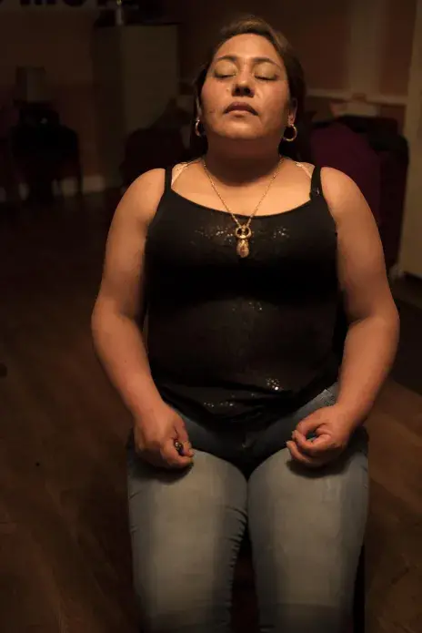 Rudyana Jimenez waits for her daughter, Aldana, to apply her makeup before going to a concert. Originally from Mendez Mamata in the Valle Alto, Rudyana came to the United States 16 years ago. She hasn’t returned to Bolivia since. She is currently in the process of attaining legal residence in the United States and hopes to visit her mother and family in Bolivia in 2017. She misses them deeply every day. “I would like to go back, to visit, it’s what I want most in this life,” she says. Image by Carey Averbook. United States, 2016.