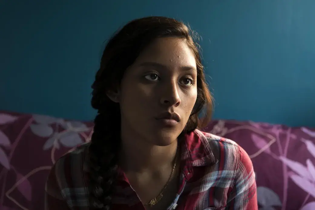 Aldana Ferrufino sits on her bed. She was born in Argentina, but her mom, Rudyana Jimenez is from Mendez Mamata in the Valle Alto. Aldana came to the United States when she was two, traveling with her mom from Bolivia to cross the Mexican-American border. Her younger brother was born in The United States, and is a citizen. As an undocumented person, she is part of the U.S. Deferred Action for Childhood Arrivals (DACA) program. On the issue of legal papers, she says, “Those who had papers and could go anywhere they wanted – they really had that privilege, even if they weren’t very say, financially stable, or happy at all. They really did have that one privilege. I just feel really sad about the fact that I couldn’t have that because I wasn’t born here; I’m not a citizen… At one point, I really, really, really wanted to be a citizen because I thought that they were just better, but I was completely wrong. It’s just a status, just a legal status.” Image by Carey Averbook. United States, 2016.