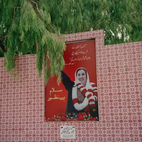 A memorial to Benazir Bhutto, former Pakistani prime minister, sits at the site of her assassination in December 2007 during a political rally in Rawalpindi, Punjab province. Bhutto was the first woman to rule a democratic Islamic nation and took a stark stance against religious extremism. Throughout her time in politics, she was threatened by the Taliban, al-Qaeda, and local extremist groups. Image by Sara Hylton/National Geographic. Pakistan, 2019.