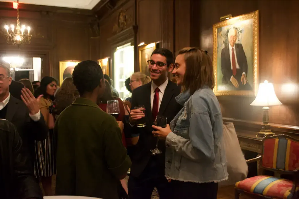 Rafael Alves de Lima (Wake Forest University) and Liz Weber (American University) mingle during the Cosmos Club reception. Image by Nora Moraga-Lewy. United States, 2019.<br />