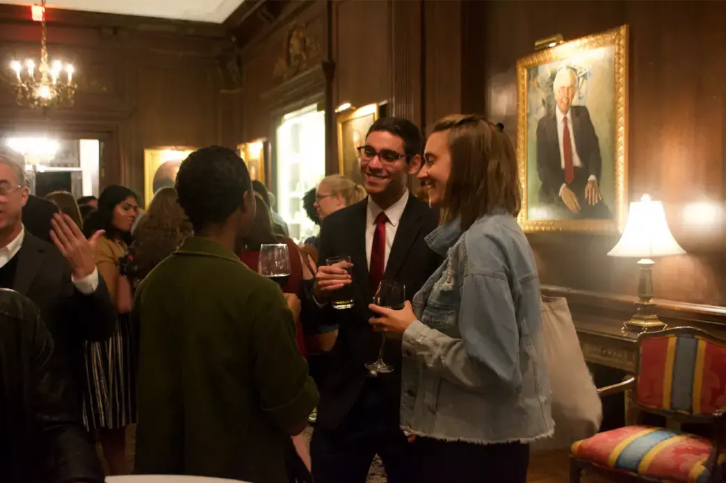 Rafael Alves de Lima (Wake Forest University) and Liz Weber (American University) mingle during the Cosmos Club reception. Image by Nora Moraga-Lewy. United States, 2019.<br />
