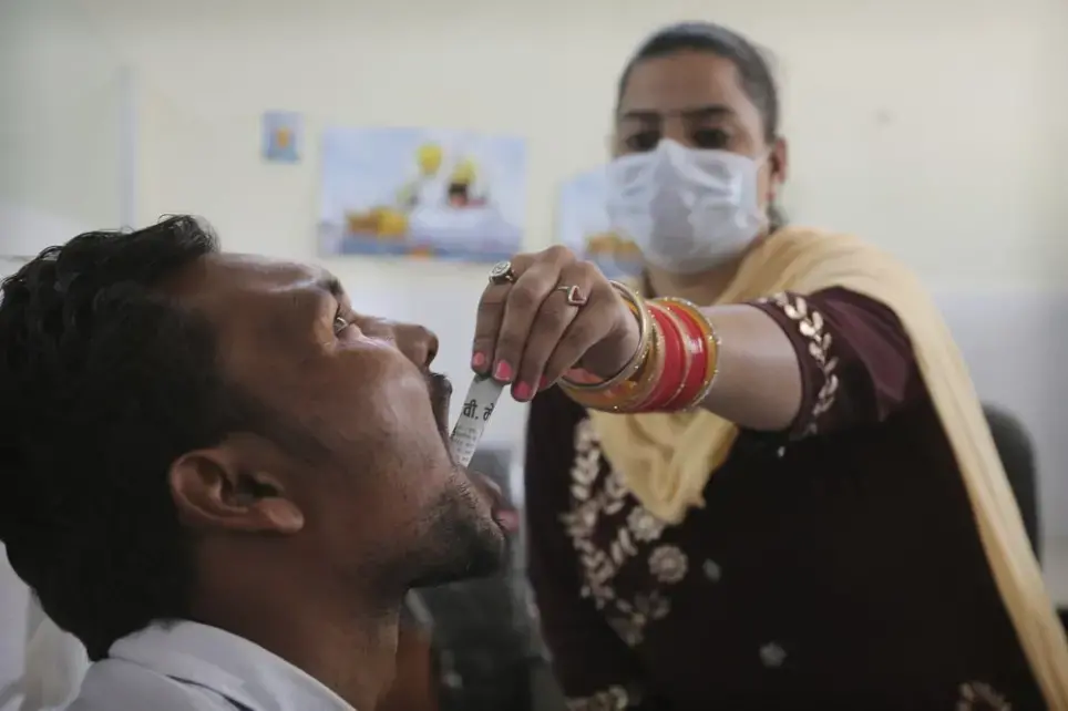 In this Thursday, Oct. 31, 2019, photo, a medic administers medicine to a recovering drug user at a de-addiction center in Kapurthala, in the northern Indian state of Punjab. Researchers estimate about 4 million Indians use heroin or other opioids, and a quarter of them live in the Punjab, India's agricultural heartland bordering Pakistan. These pills, the world had been told, were safer than the OxyContins, the Vicodins, the fentanyls that had wreaked so much devastation. But now they are the root of what the United Nations named “the other opioid crisis,' an epidemic featured in fewer headlines than the American one, as it rages through the most vulnerable places on the planet. Image by Channi Anand / AP Photo. India, 2019.