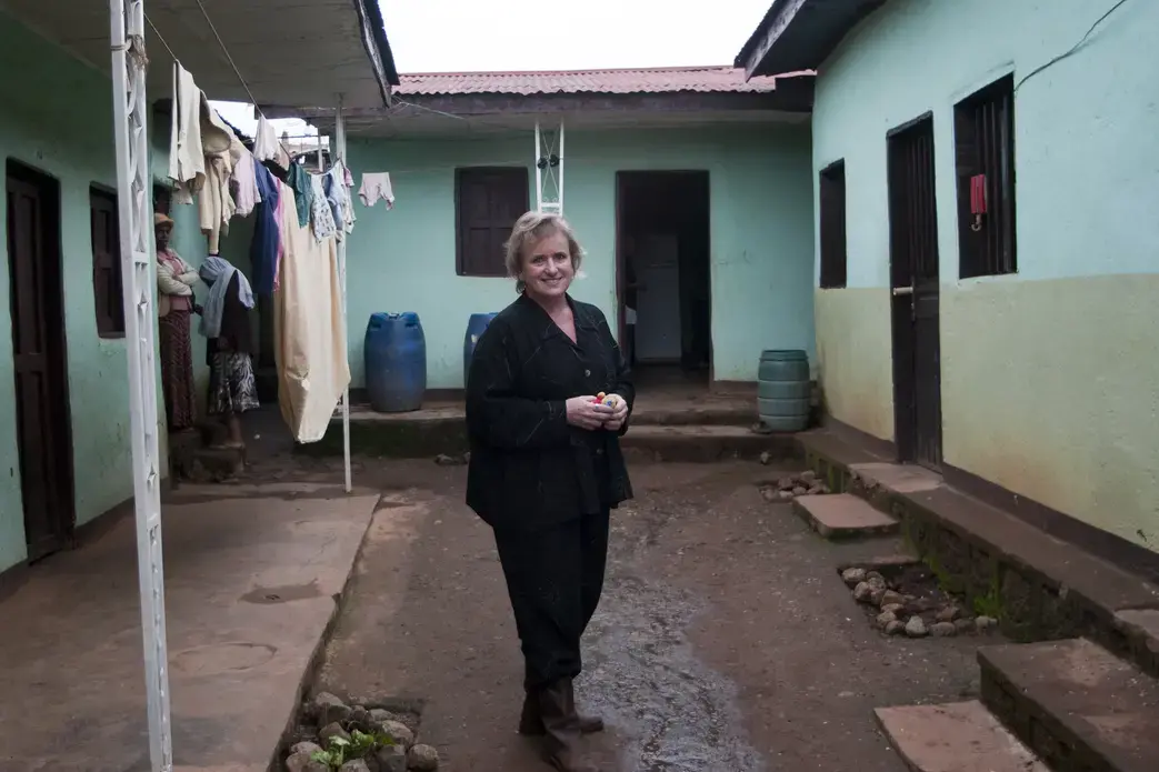 Stephne Bowers, the director of the Christian World Adoption orphanage, stands on the grounds of their current and temporary orphanage location. Image by Michael Tsegaye. Ethiopia, 2011. image