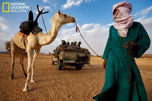 Tuareg militiamen encounter one of their nomadic kinsmen. Image by Brent Stirton for National Geographic. Mali, 2011. Tuareg militiamen encounter one of their nomadic kinsmen.