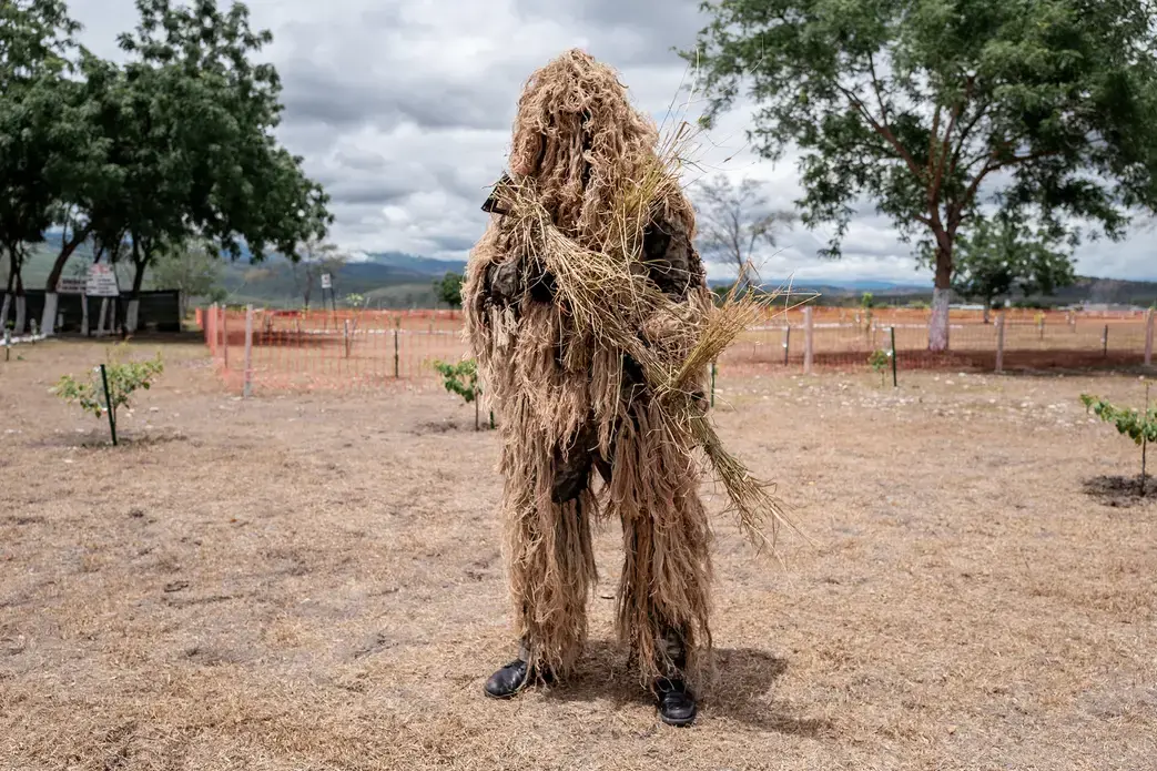 A soldier in the Peruvian army in camouflage and prepared to watch over the country’s borders. Image by Marcio Pimenta. Peru, 2019.