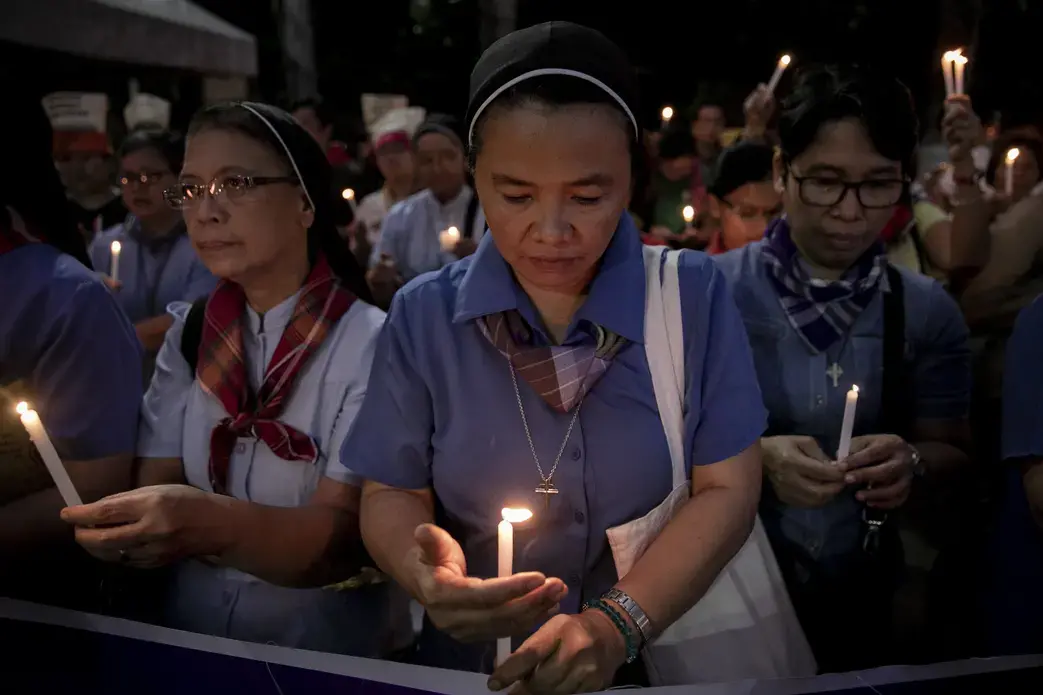 Nuns light their candles during a demonstration calling for "truth, justice, and peace" across Malate Church in Manila. Image by Eloisa Lopez. Philippines, 2019. Nuns light their candles during a demonstration calling for "truth, justice, and peace" across Malate Church in Manila. Image by Eloisa Lopez. Philippines, 2019.