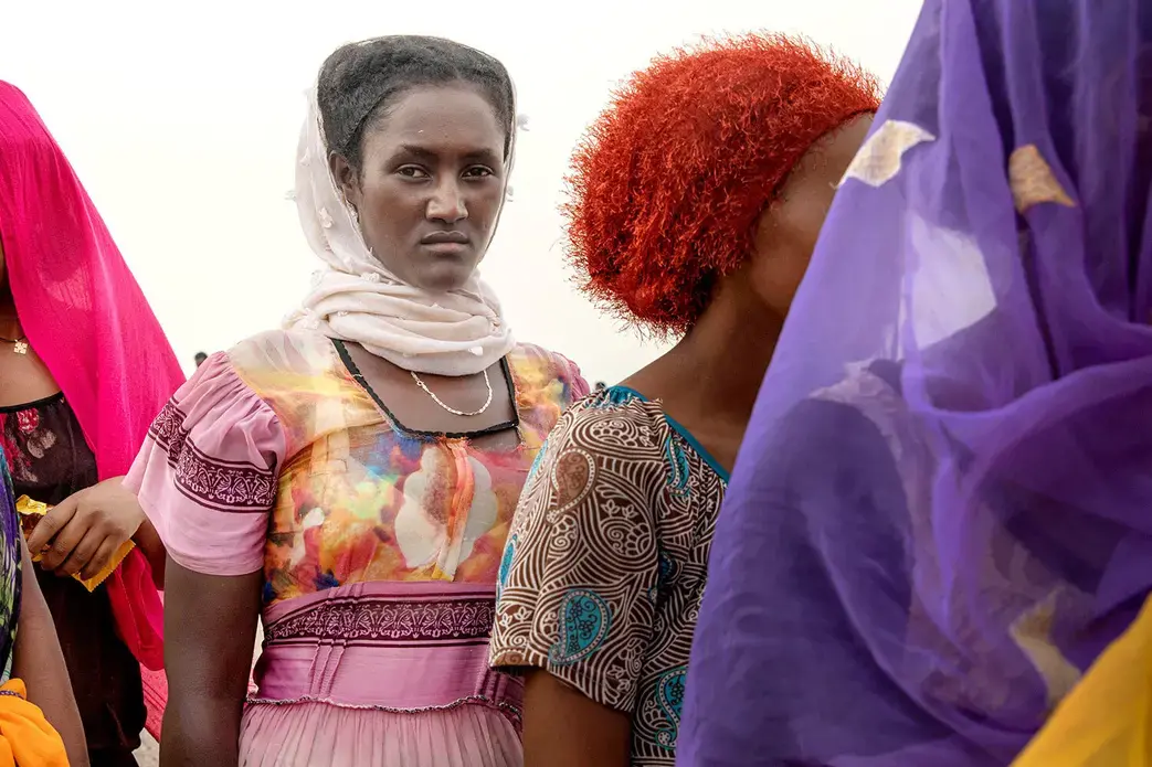 In this July 25, 2019 photo, Ethiopian Tigray migrants stand in lines as they are counted by smugglers after arriving to the coastal village of Ras al-Ara from Djibouti, in Lahj, Yemen. Image by Nariman El-Mofty / AP Photo. Yemen, 2019.