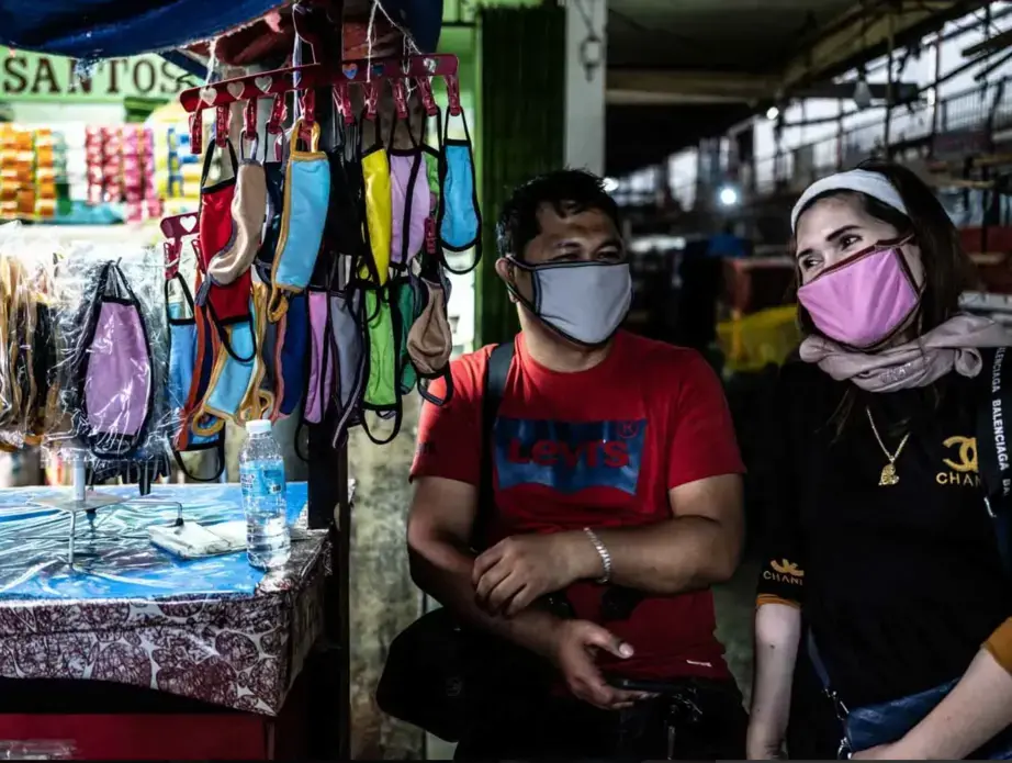 Abdul and Hanifa are selling cloth masks in the public market. Before the pandemic, they sold cellphones, which are now not considered essential goods. They started selling masks to continue to have an income during the lockdown. Image by Xyza Bacani. Philippines, 2020.