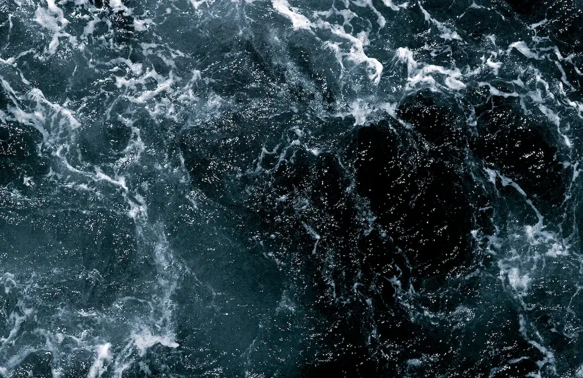 a birds-eye-view of churning ocean waves