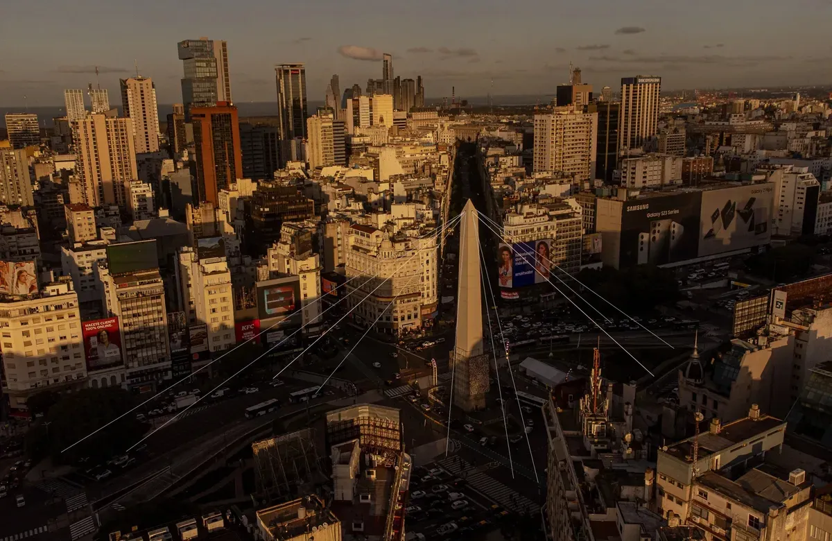 an aerial shot of a city with a giant bridge and many skyscrapers