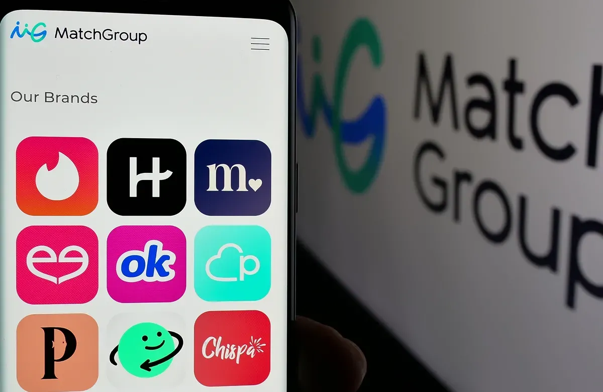 Image of phone with dating apps like Tinder and Hinge next to screen with brand logo for Match Group company