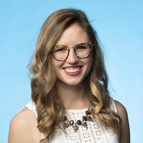 Emily_Baumgaertner_0.jpeg photo of emily in front of blue background