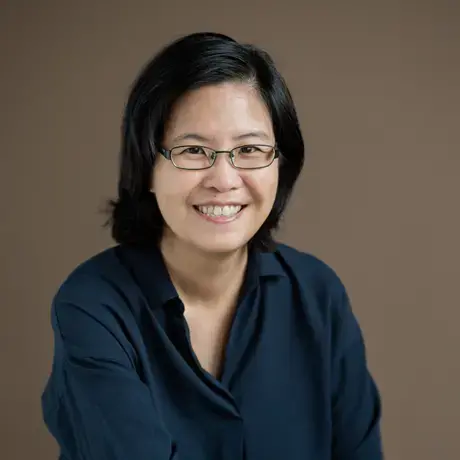 Image of a person wearing glasses and a dark blue shirt.