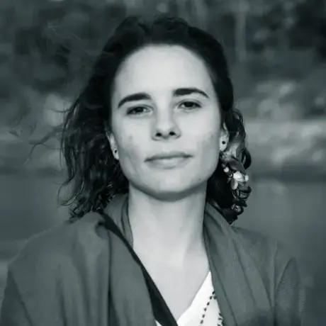 Image of a person wearing a jacket and a blouse.