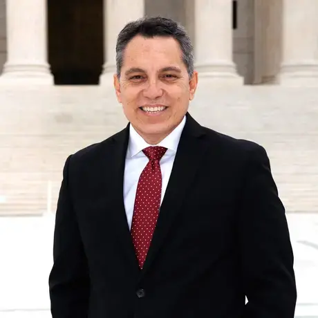 Man in black suit and red tie