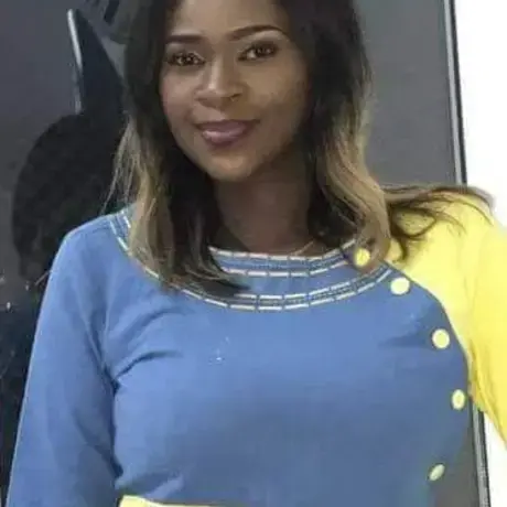 A woman in a color block blue and yellow dress.