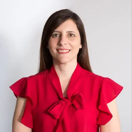 a woman with long dark straight hair wearing a bright red blouse